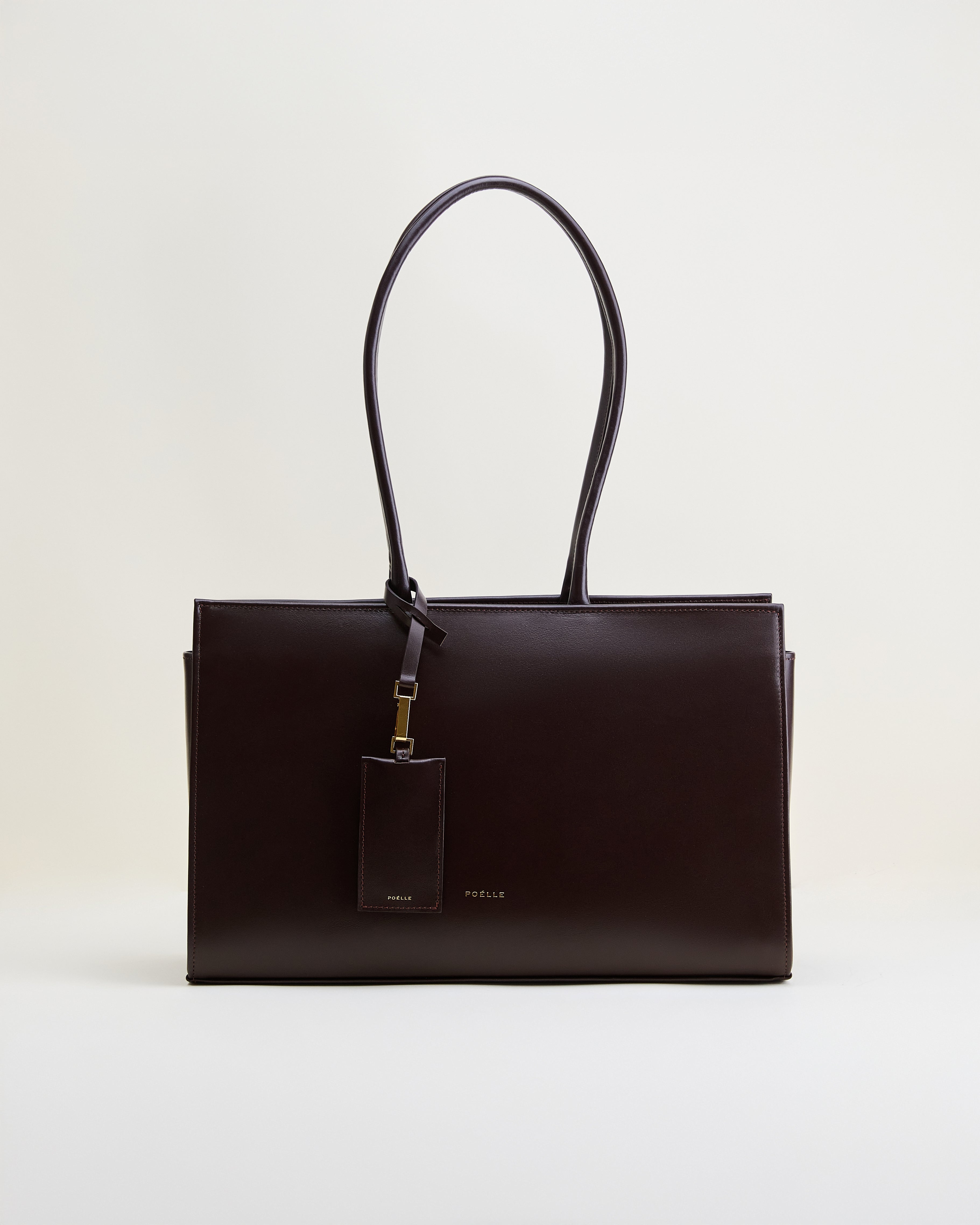 Poelle Atelier brown leather tote bag with long handles and attached leather tag