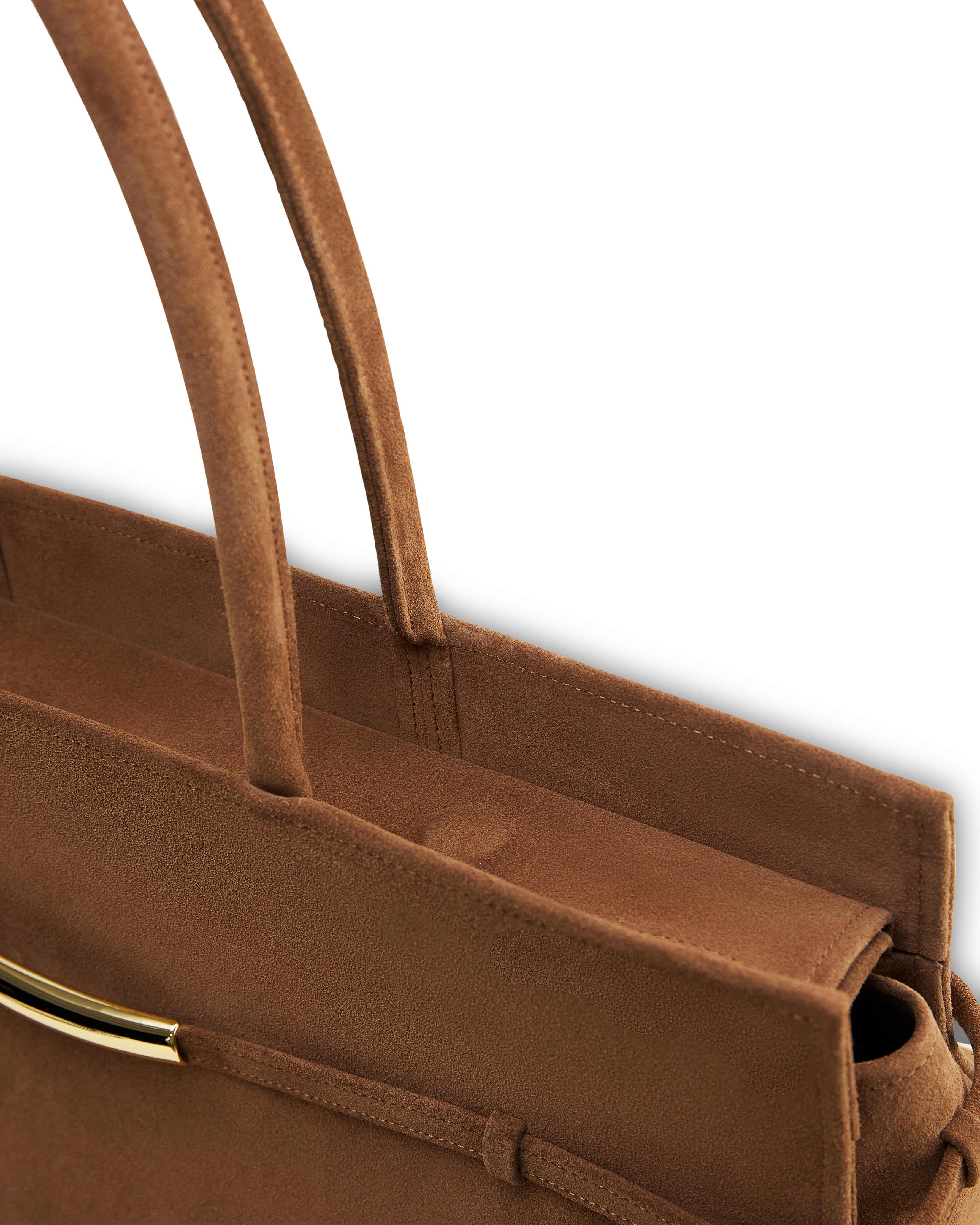 Close-up of luxury suede caramel bag handles and top edge with gold-tone hardware detail