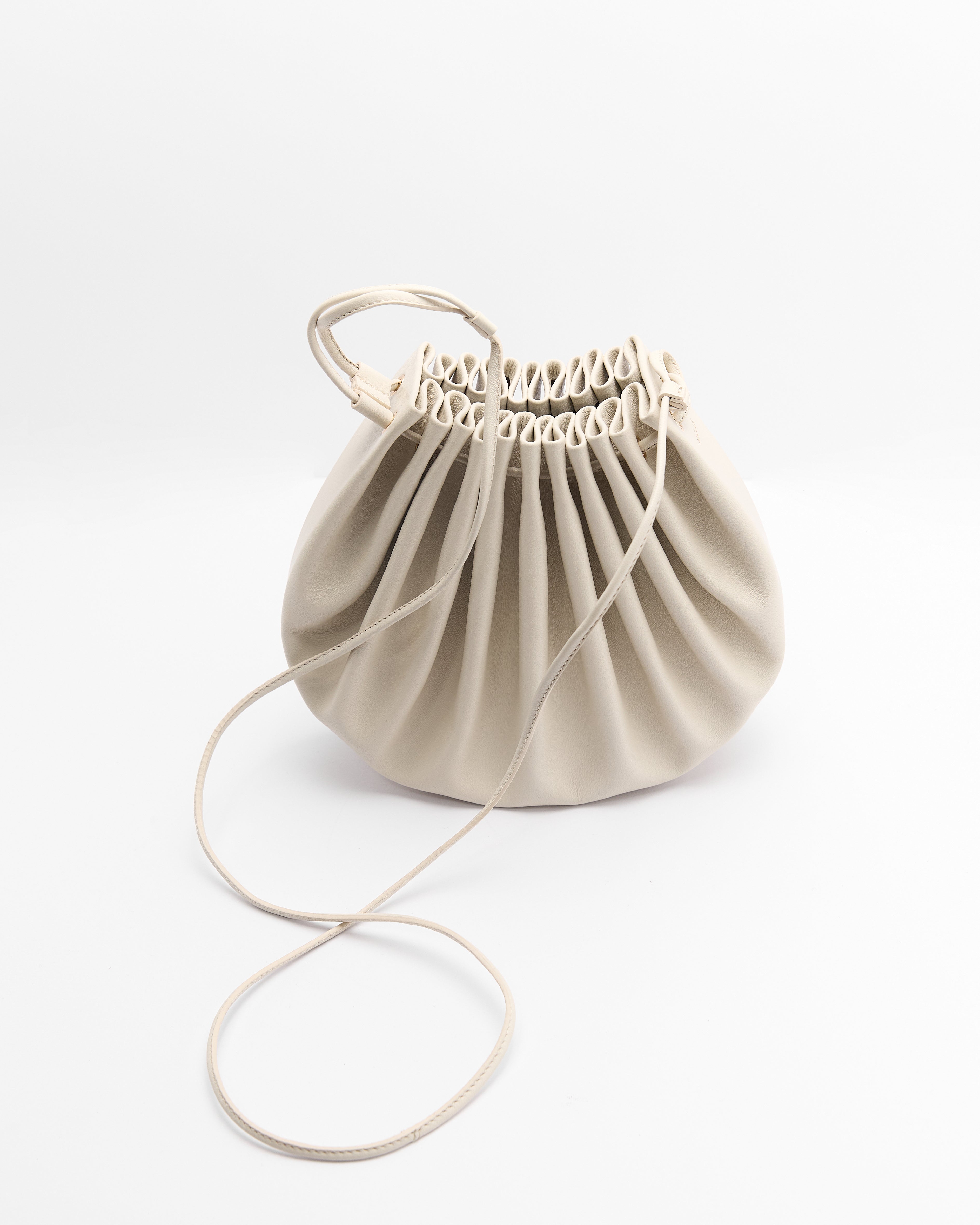 Poelle Atelier beige luxury summer crossbody bag with ruched design and adjustable strap