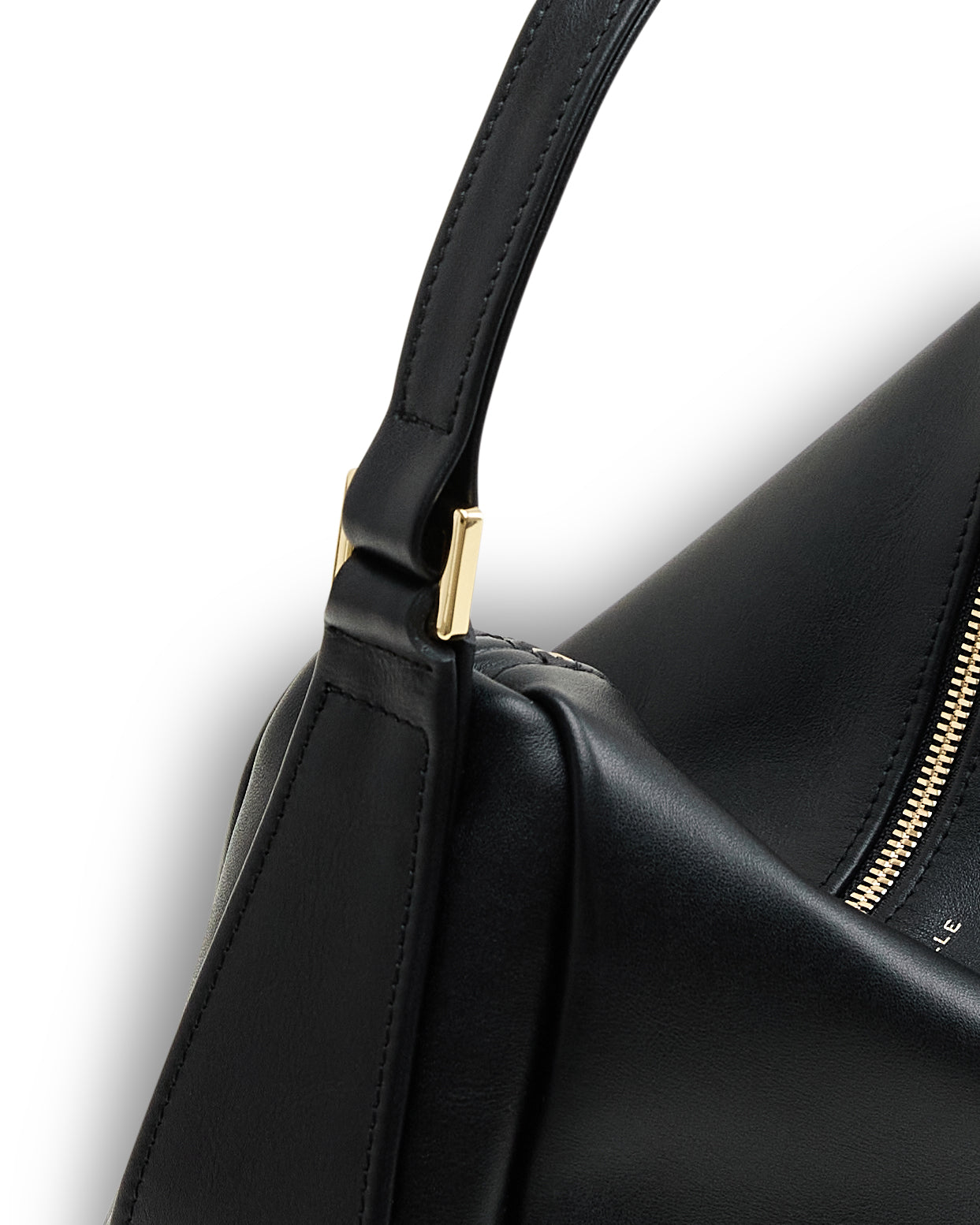 Close-up of black minimalist leather bag for women by Poelle Atelier with gold hardware and zipper detail