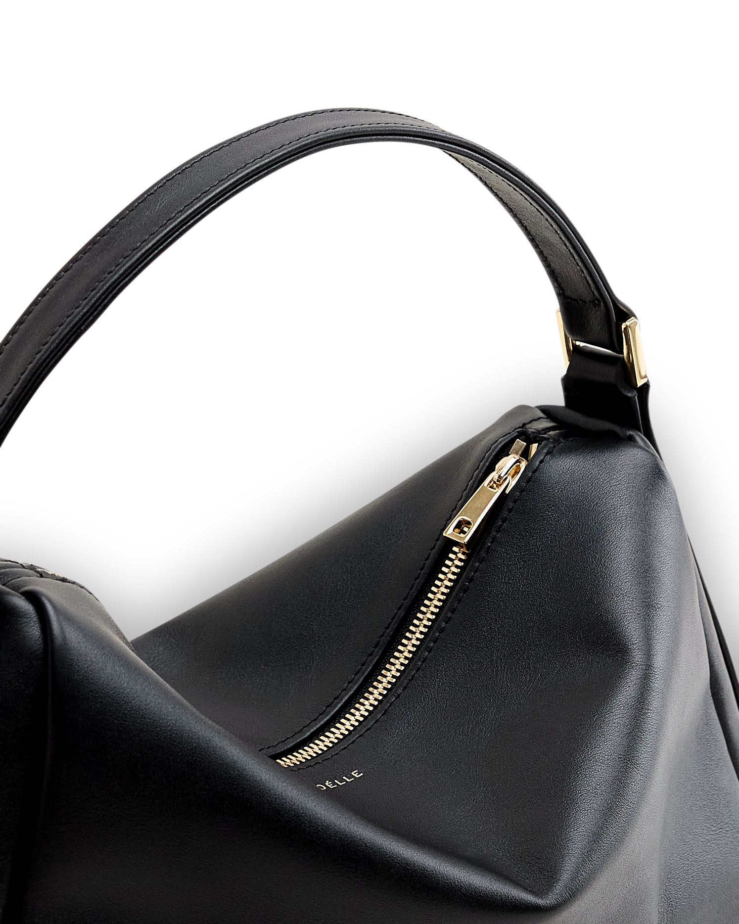 Black minimalist leather bag for women with gold zipper and sturdy handle by Poelle Atelier