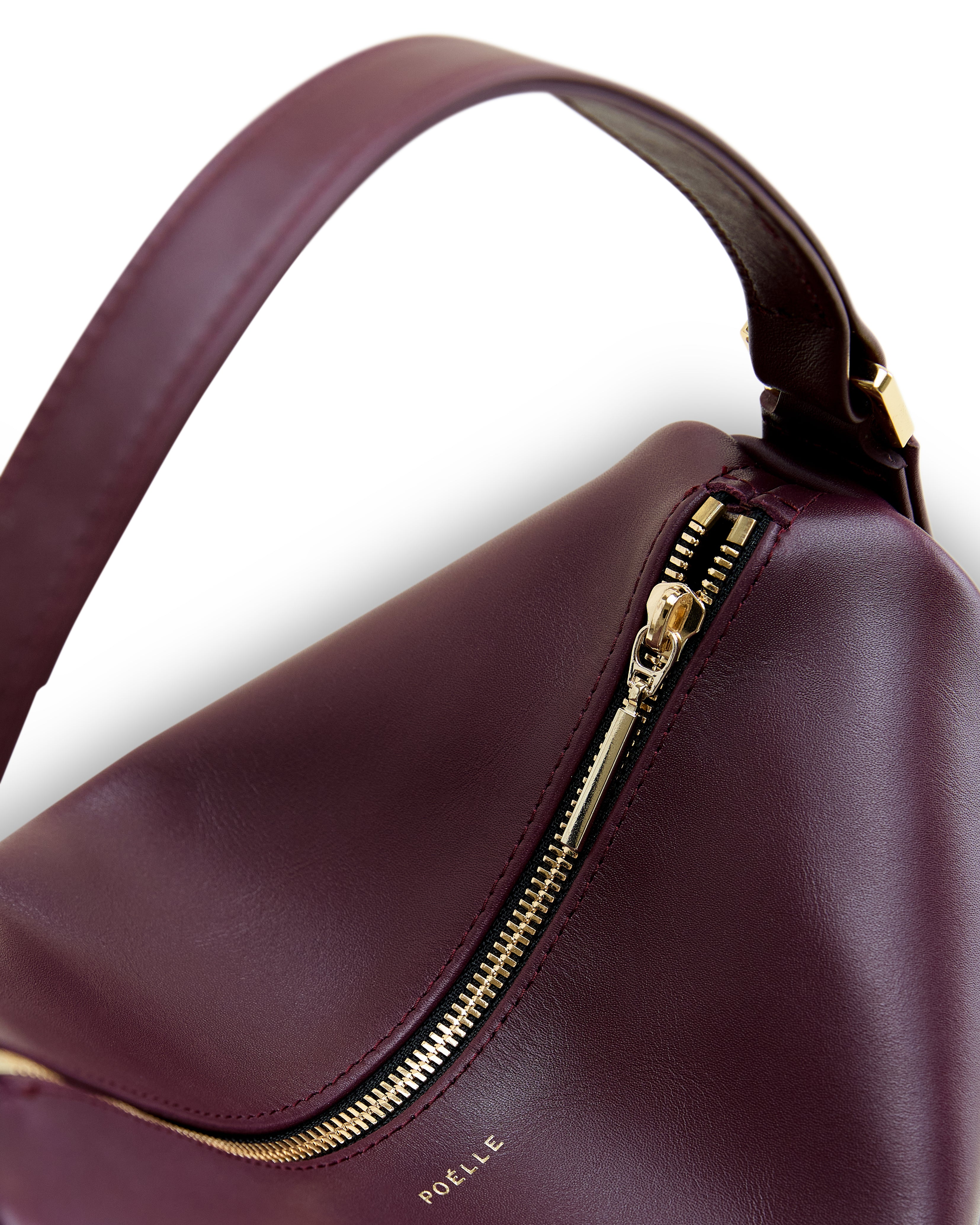 Poelle Atelier modern structured leather bag in deep burgundy with gold zipper detail