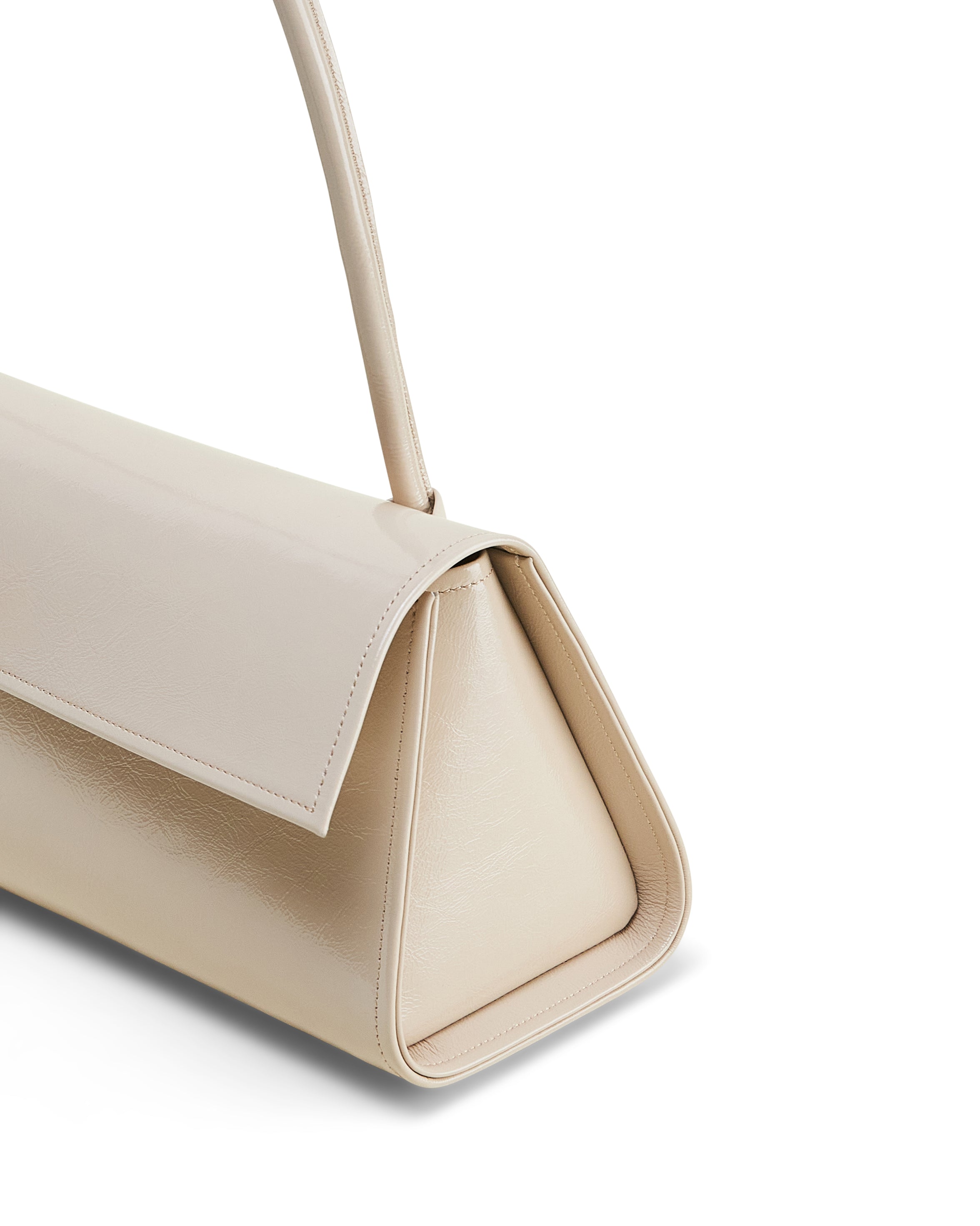 Poelle Atelier beige high-end fashion leather bag with sleek triangular design and shoulder strap