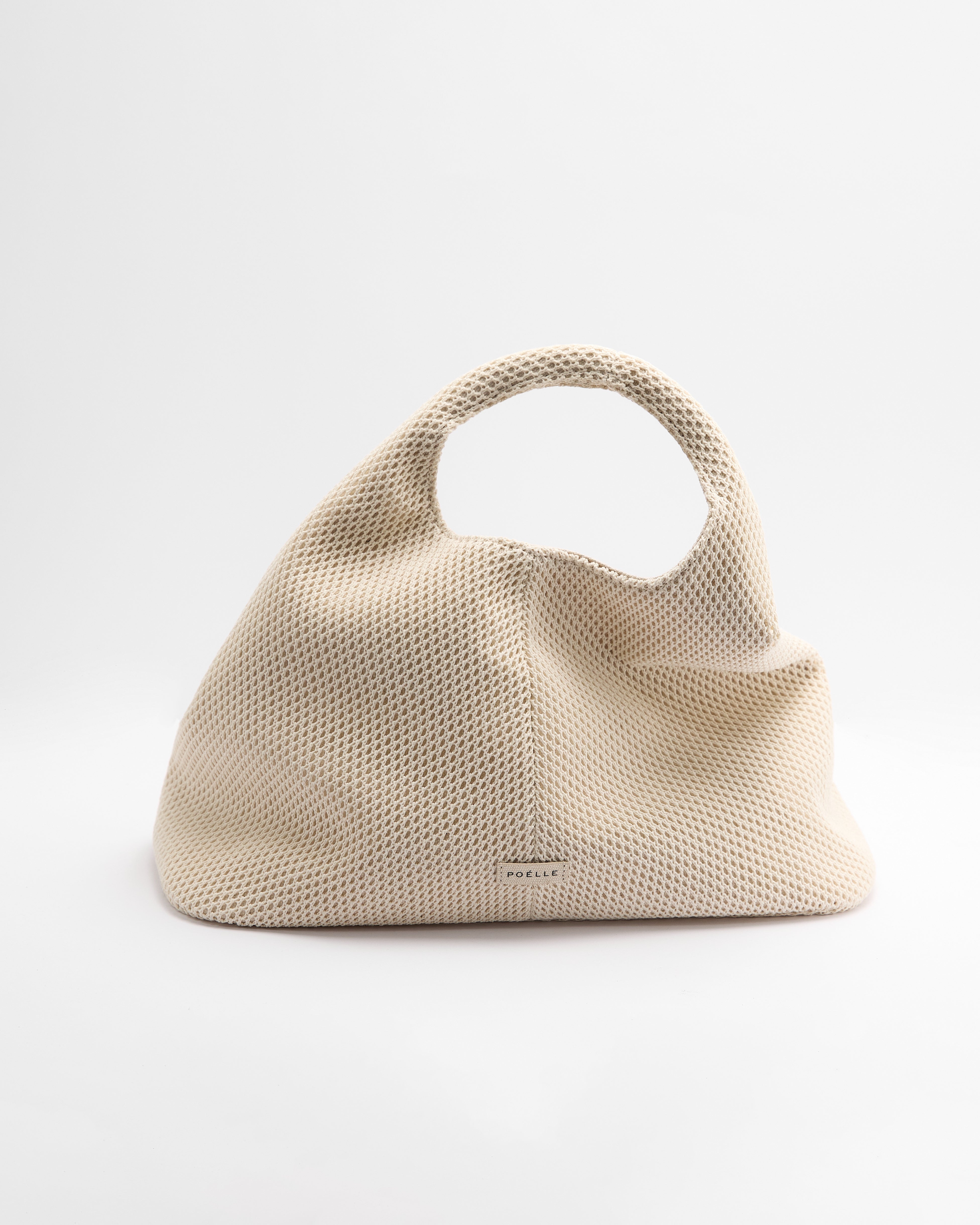Poelle Atelier luxury minimalist summer bag in beige mesh with rounded handle and soft structure