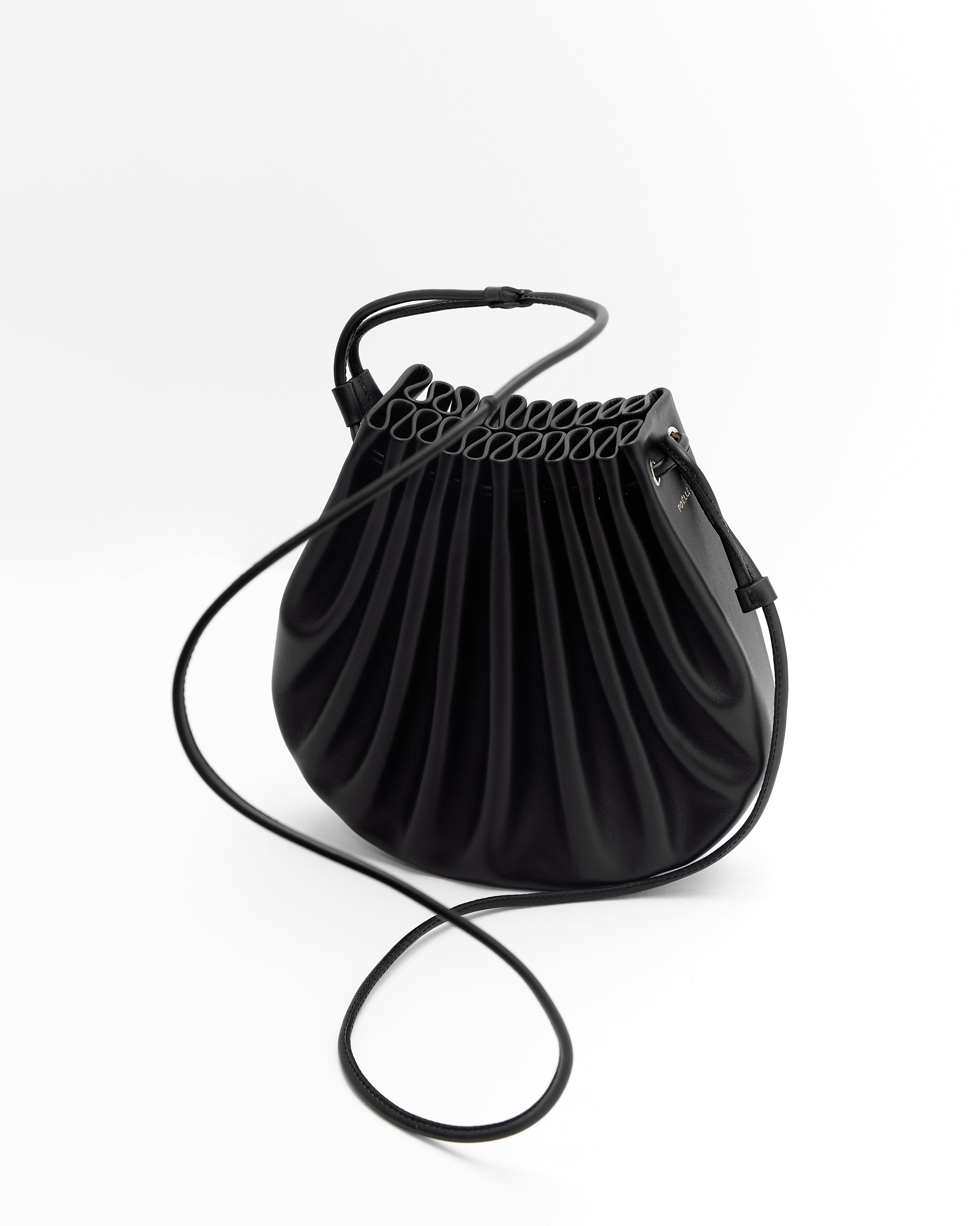 Black luxury summer crossbody bag with pleated design and adjustable strap by Poelle Atelier