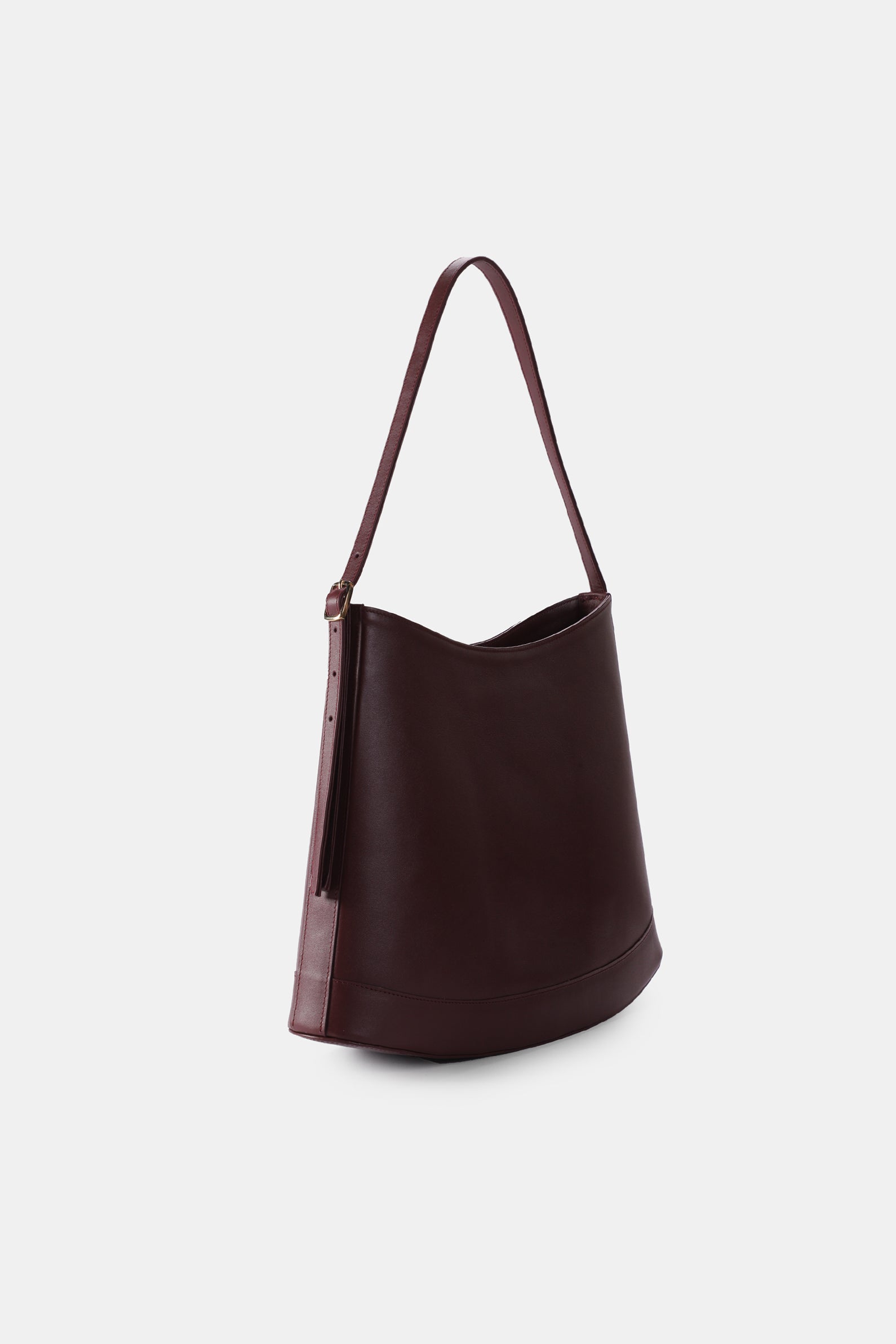 Poelle Atelier luxury minimalist sculptural bag in dark brown leather with a single shoulder strap