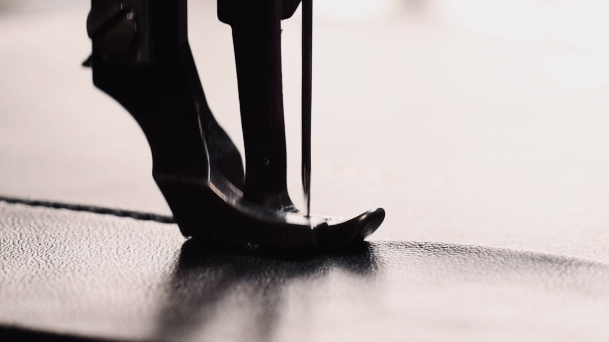 The POELLE name being embossed on leather