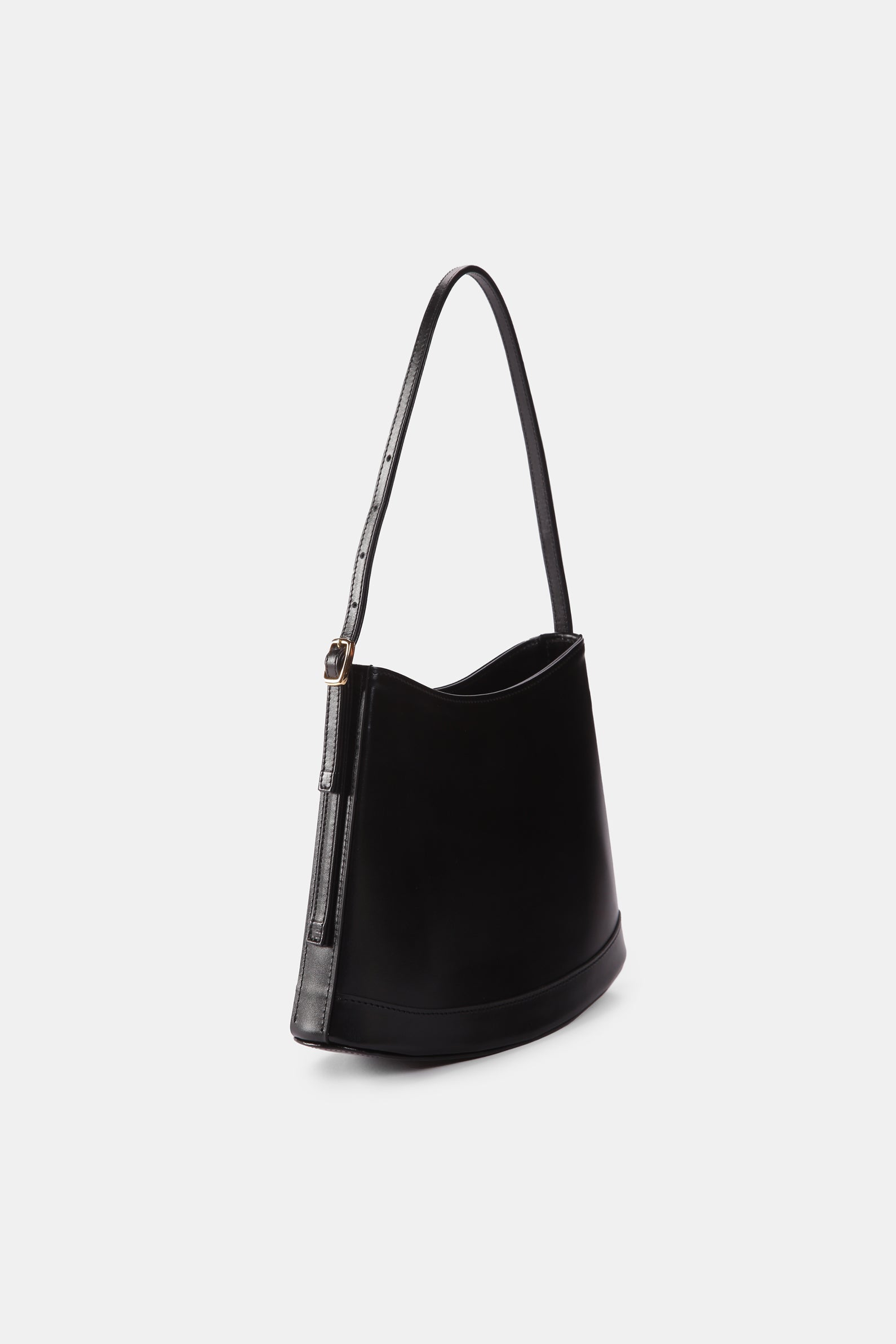 Poelle Atelier luxury minimalist leather bag in black with adjustable shoulder strap and sleek design
