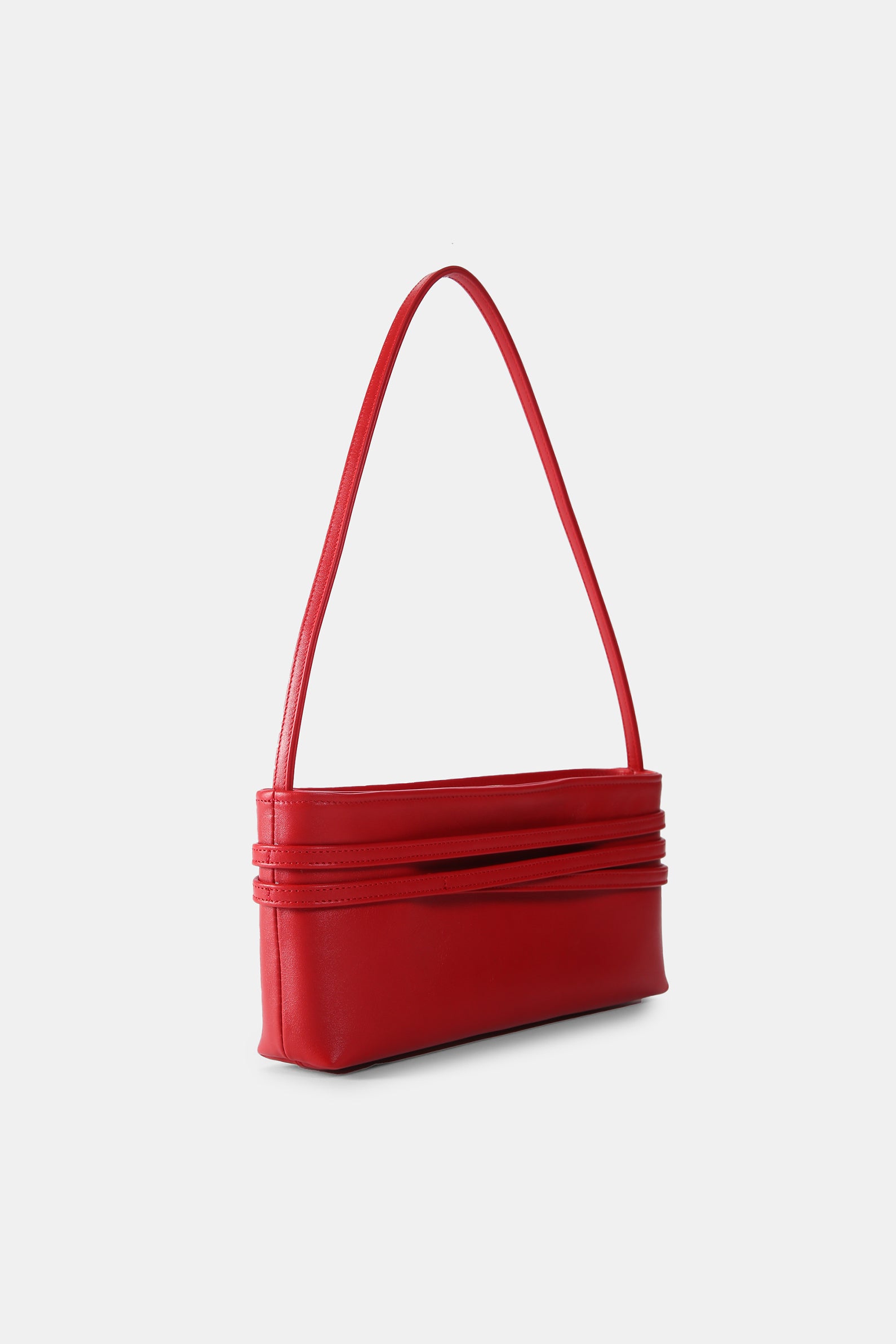 Poelle Atelier minimalist red leather shoulder bag with sleek design and long strap
