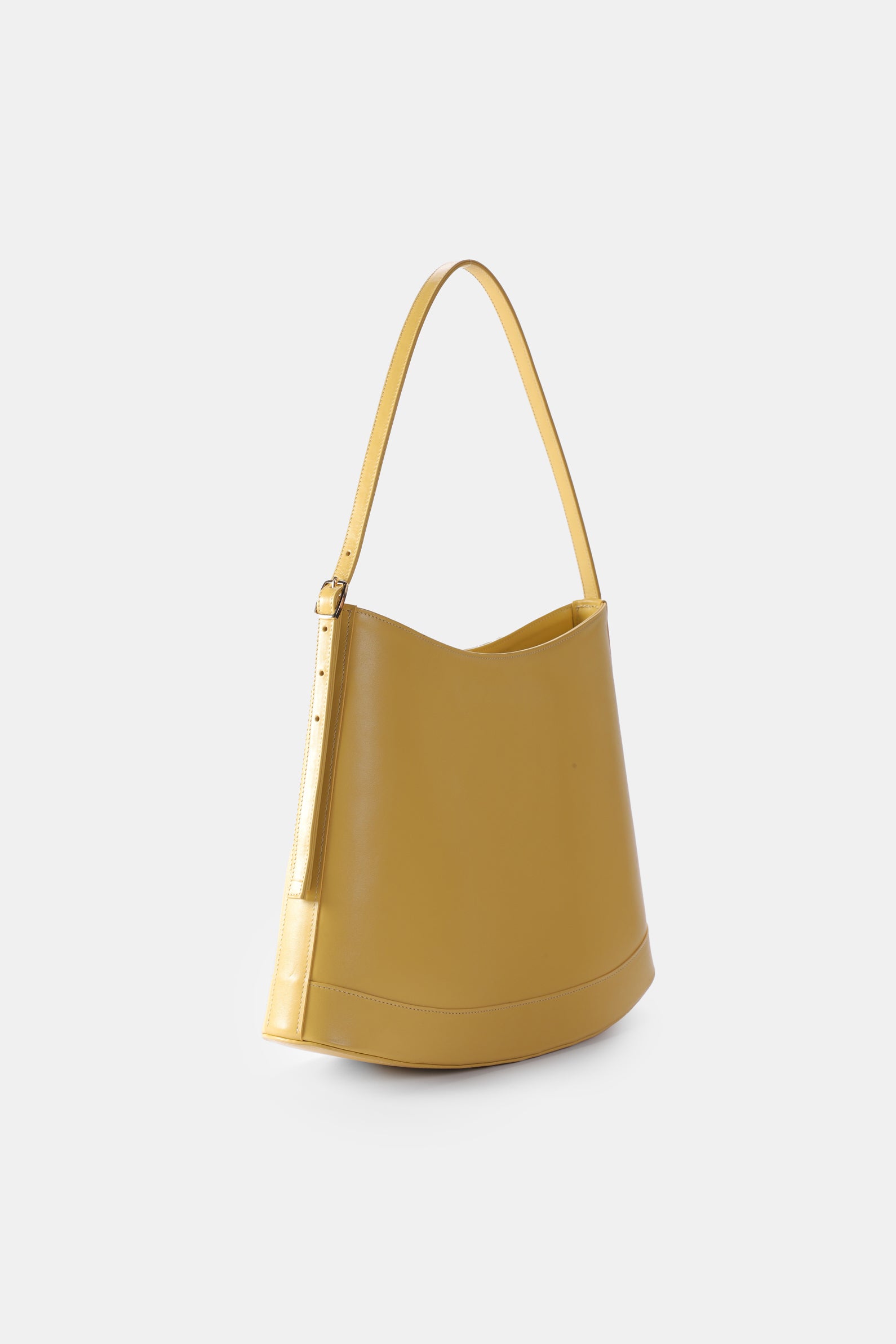 Poelle Atelier luxury minimalist sculptural bag in mustard yellow leather with adjustable shoulder strap